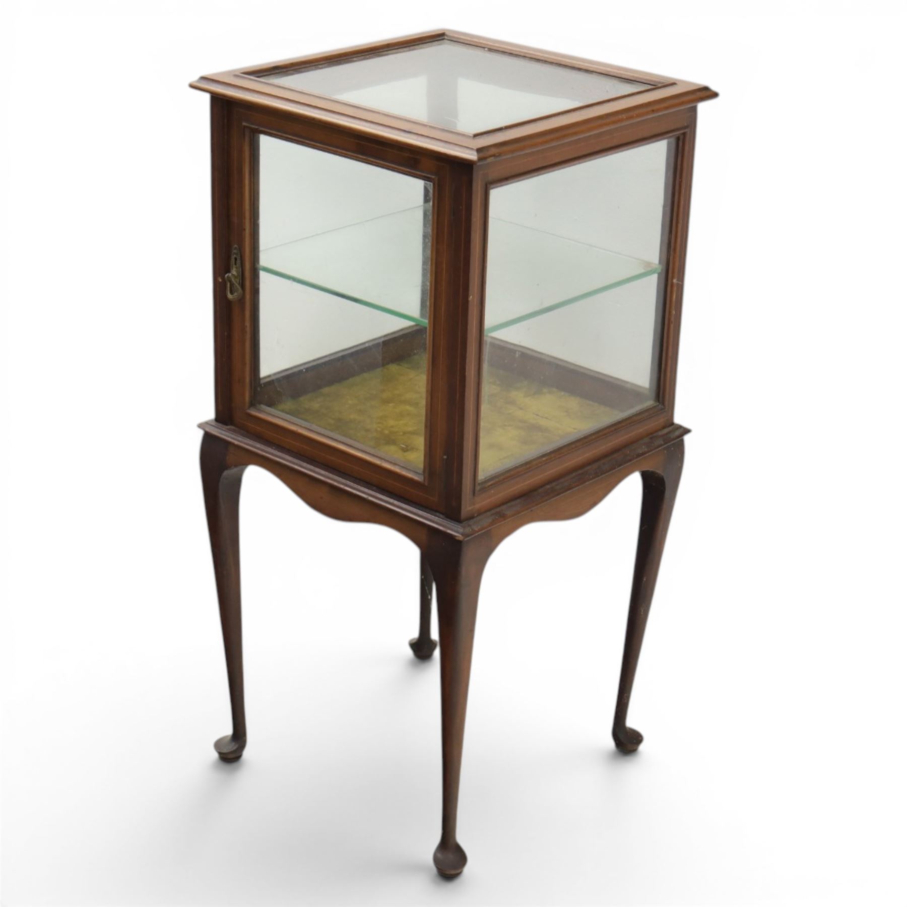 Edwardian bijouterie two tier table, glazed top and sides with inlay surround, glazed door enclosing a single shelf and baized lined interior, raised on cabriole supports
