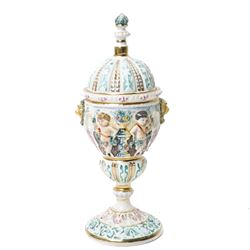 Capodimonte vase and cover decorated with a raised pattern of cherubic figures H32cm, another vases and cover with panels of figures H33cm, bowl and cover with similar decoration D20cm and two other Capodimonte pieces (5)
