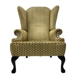 Georgian design armchair, high wing back, mahogany ball and claw feet, upholstered in embossed studded fabric