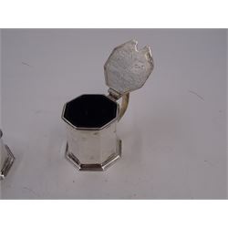 1920s silver three piece cruet set, comprising mustard pot and cover, pepper and open salt, each of faceted octagonal form, the mustard pot with pierced thumbpiece and capped handle, hallmarked Stokes & Ireland Ltd, Chester 1923 & 1924, max height 8.5cm, mustard and salt with original blue glass liners