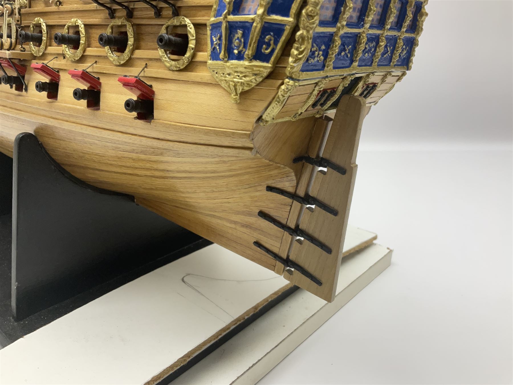 Wooden kit built model of HMS Neptune, 1:90 scale, with detailed rigging to three masts and a row of cannons to either side, upon ebonised wooden base, including stand H71cm