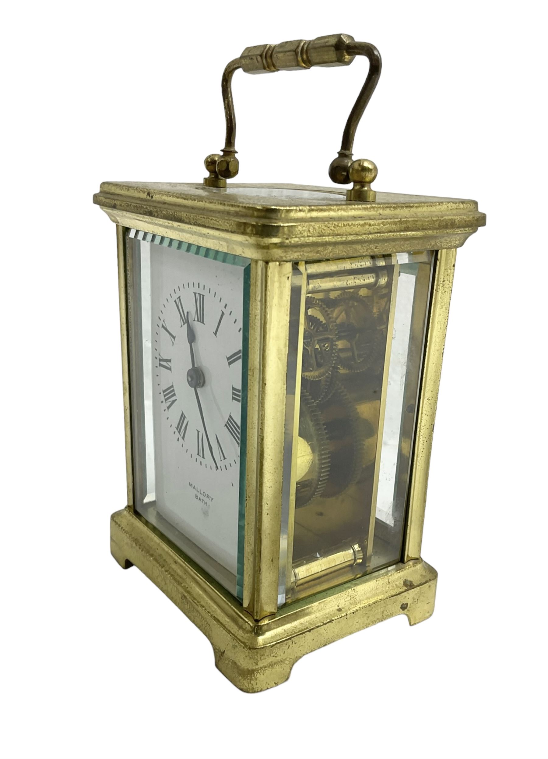 French - 20th century timepiece carriage clock, in a corniche case with carrying handle, enamel dial with Roman numerals, minute track, spade hands and retailers name “Mallory, Bath”, cylinder platform escapement, wound and set from the rear.