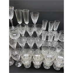  A large quantity of clear glassware, a number of examples with engraved, etched and cut decoration, to include a set of twelve brandy balloon glasses, sixteen champagne glasses, a set of six cordial glasses, a decanter, etc. (Qty).   