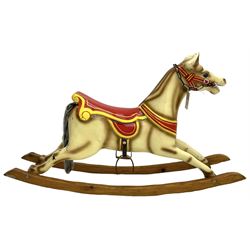 20th century rocking horse, painted body, glass eyes, metal stirrups and chain, wooden bow rocker