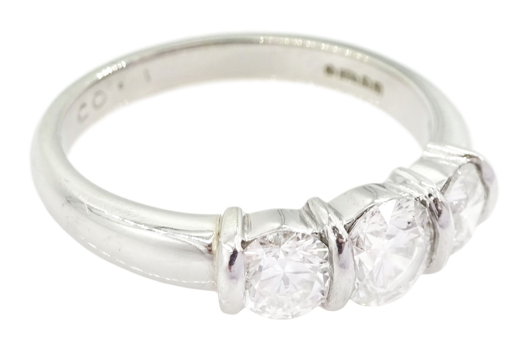 Platinum three stone round brilliant cut diamond ring by FEU, London 2003, total diamond weight 1.03 carat