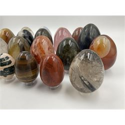 Collection of twenty-one hardstone specimen eggs, including labradorite, calcite, orbicular jasper, tiger's eye, smokey quartz, fossilised wood etc, originally part of the collection of the late Stanley J Seeger