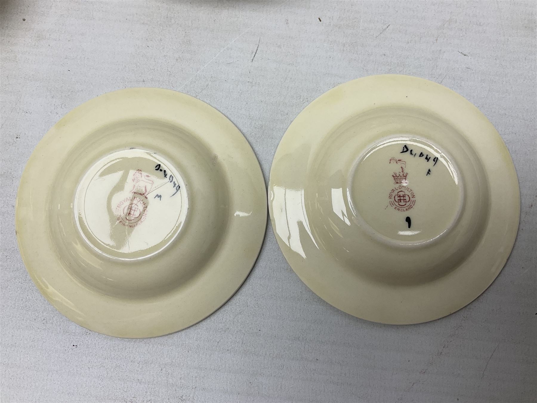 Early 20th century Art Deco Royal Doulton Pansies pattern octagonal teawares, comprising three larger teacups and saucers, three smaller teacups and saucers, open sucrier, two jugs, slop bowl, six side plates, two larger plates, two small circular dishes and one long twin handled rectangular dish, all with printed marks beneath, Rd No 597783, pattern no D4049