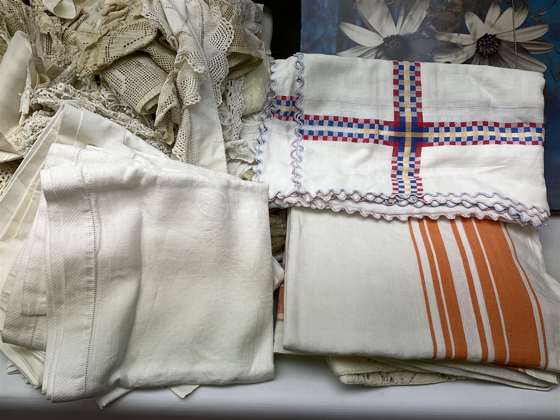 Large quantity of table linen and Victorian and later lace, framed machine tapestry depicting Greece, embroidered wall hanging decorated with a woodland scene with deer and blossoming tree, embroidered linen decorated with floral design, crochet, etc