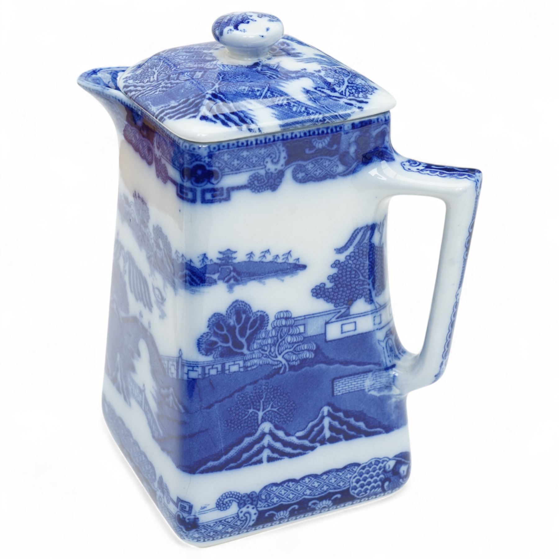 Large Spode Italian blue and white jug H23cm, 20th century Delft vase and cover decorated with landscape and floral design H38cm, Ringtons Tea Merchants blue and white tea caddy H20cm and a Ringtons jug (4)