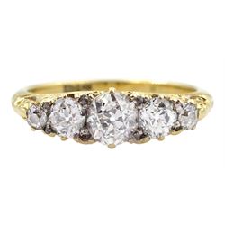Early 20th century gold graduating five stone old cut diamond ring, with diamond accents set between, stamped 18ct, principal diamond approx 0.40 carat, total diamond weight approx 0.80 carat