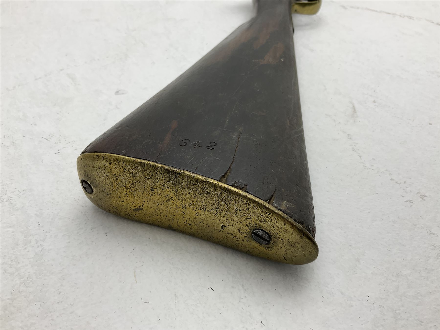 20th century Indian percussion musket, the 76cm barrel with two bands, indistinctly inscribed lock-plate, walnut full stock stamped 642 with brass butt and trigger guard and under barrel ramrod channel L121cm overall