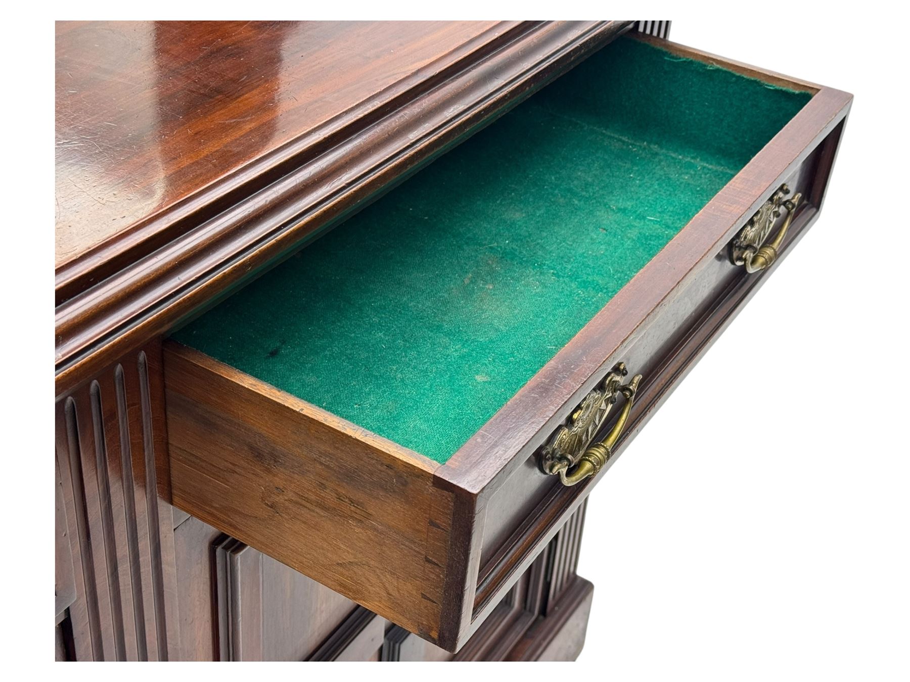 Victorian mirror back press, the arched corniced mirror back flanked by half columns, the base fitted with three drawers and four moulded panel doors with geometric detail, on a block plinth