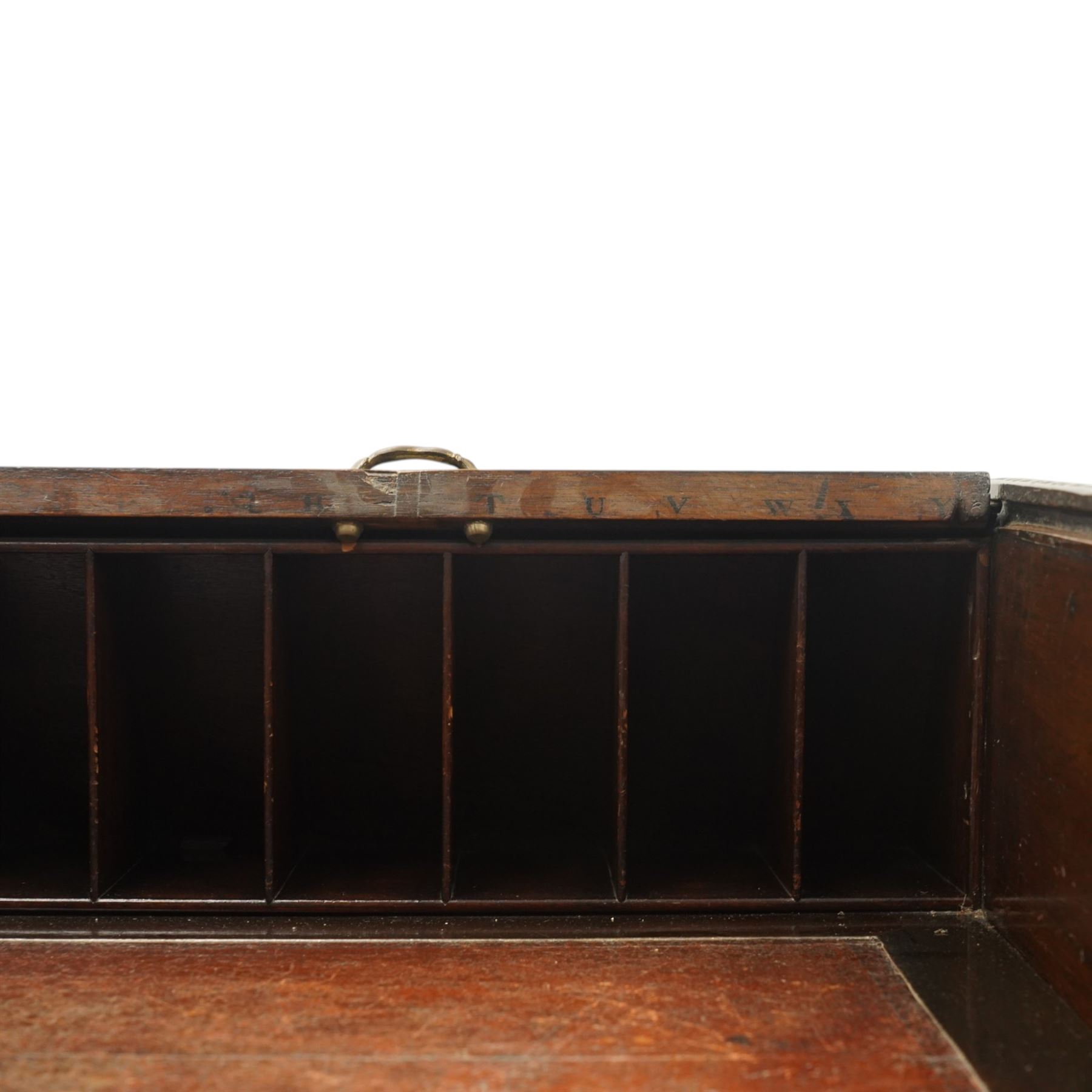 Late 18th century George III mahogany Chippendale design cylindrical roll-top desk carved profusely with geometric and foliate blind-fretwork throughout, the tambour-roll top opening to reveal pigeon holes over an inset red leather writing surface, fitted with two frieze drawers below, raised on square supports with inner chamfer terminating to brass castors, circa 1780s