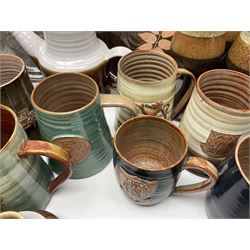 Wold studio pottery tankards, in various colours and relief decoration together with other studio items including vases, jugs and pots 