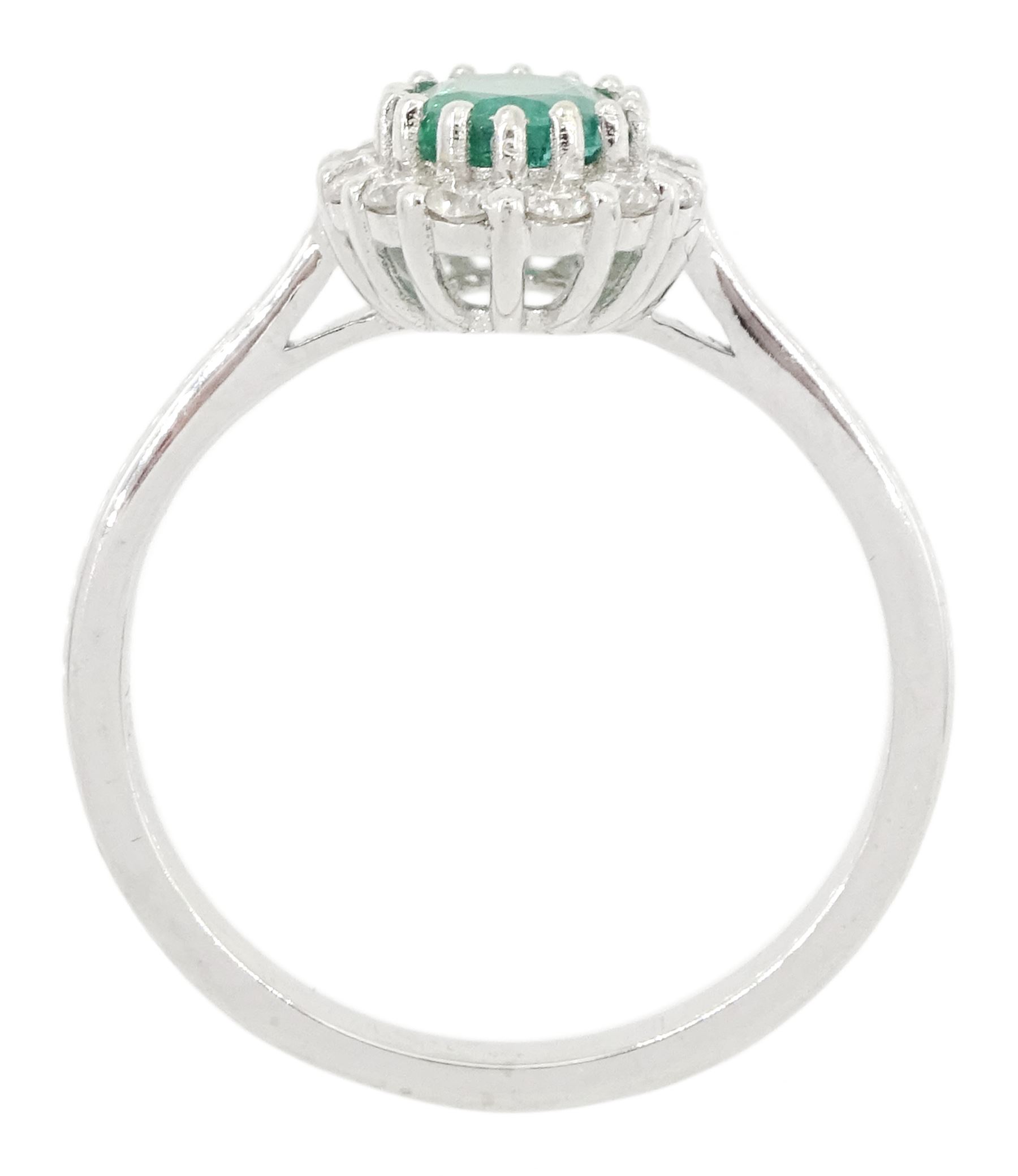 18ct white gold oval cut emerald and round brilliant cut diamond cluster ring, emerald approx 0.85 carat, total diamond weight approx 0.30 carat