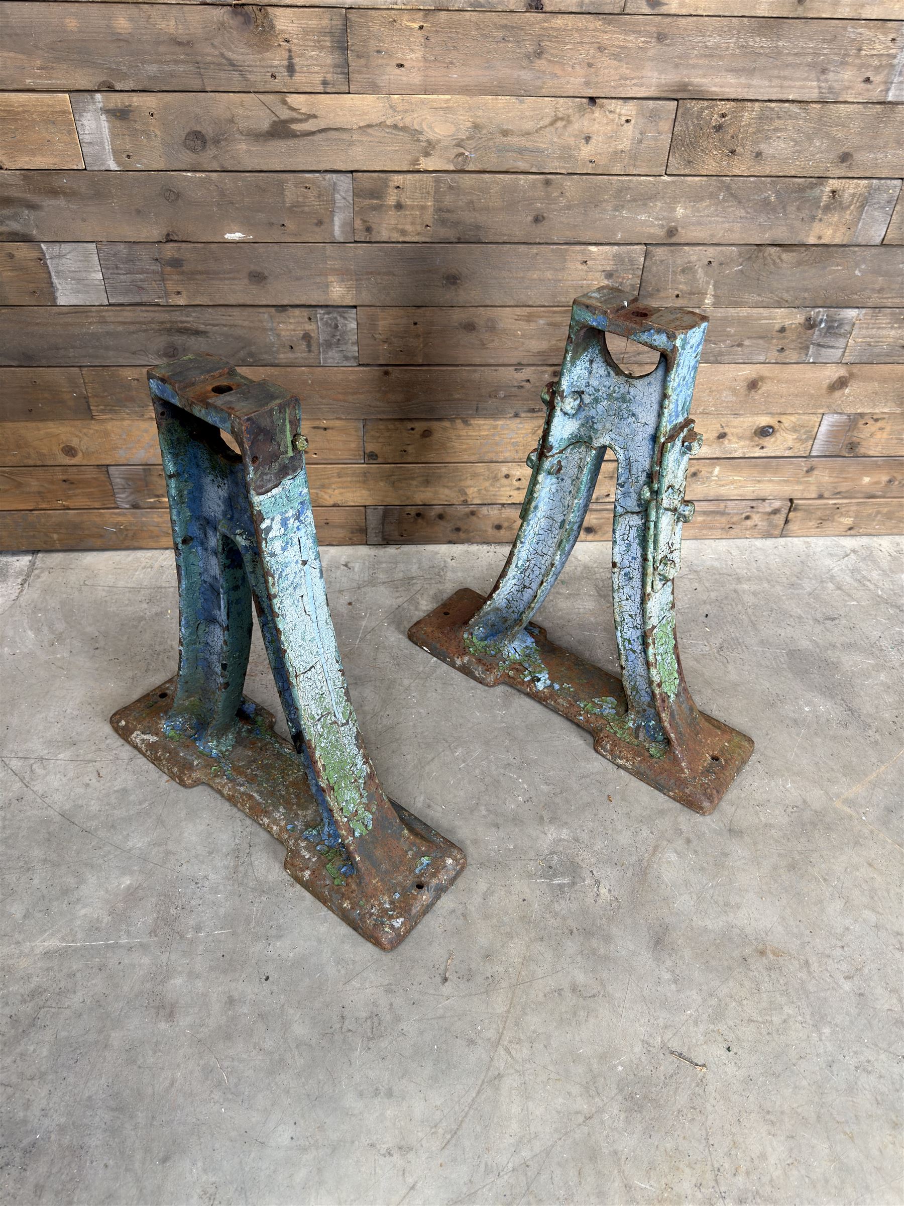 Pair of late 19th century heavy cast iron garden industrial trestles, painted in distressed blue paint