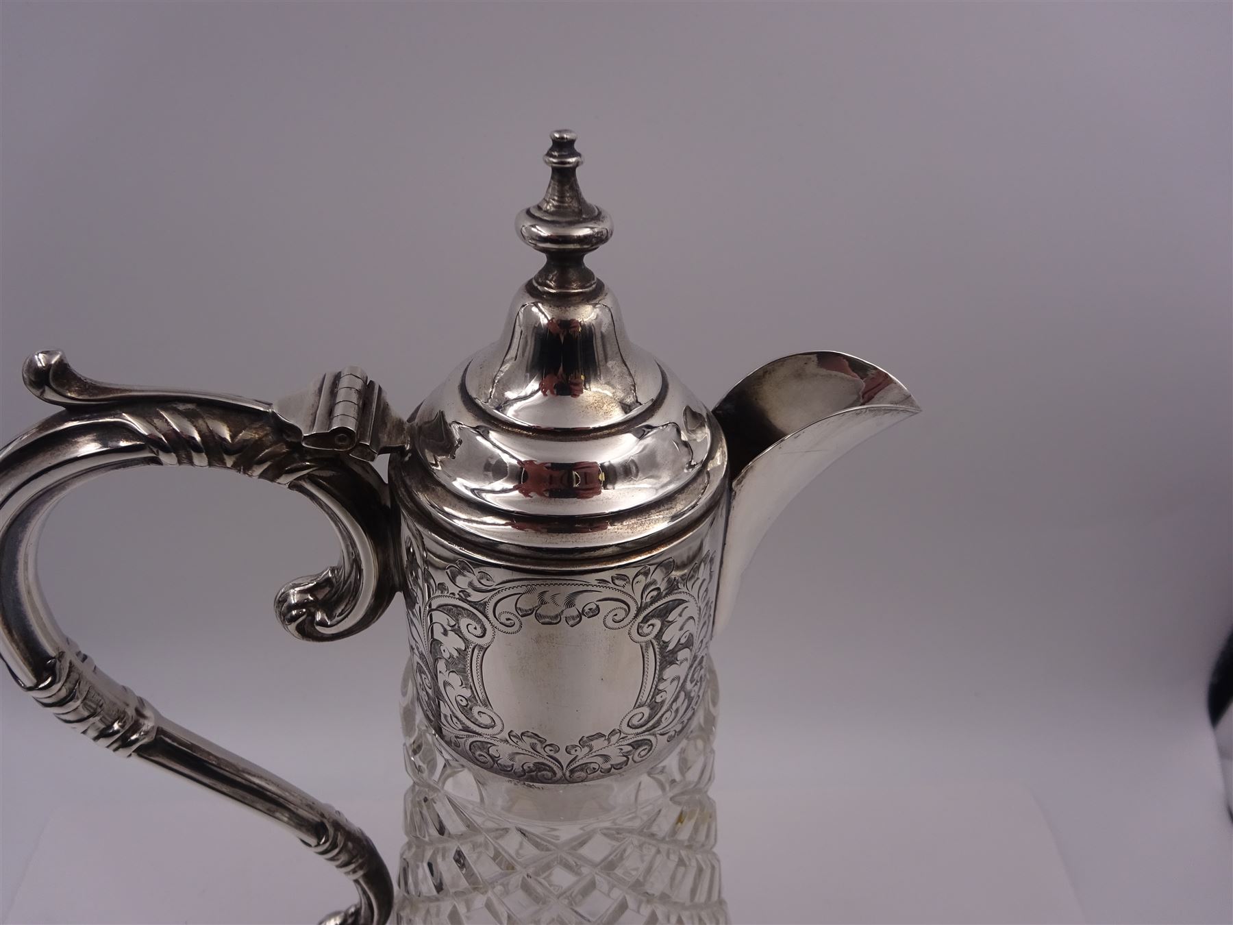 Modern silver mounted glass claret jug, with capped C scroll handle, engraved collar and urn finial to cover, hallmarked Charles S Green & Co Ltd, Birmingham 1973, H32.4cm