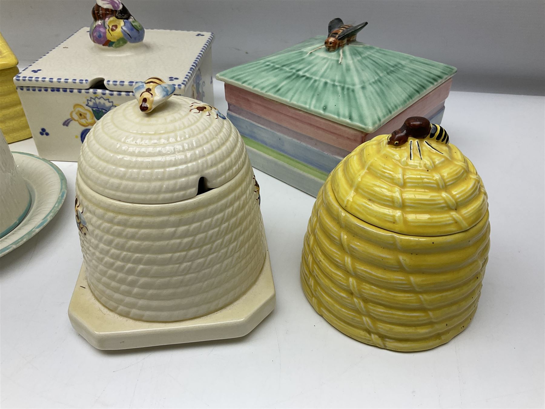 Clarice Cliff for Wilkinson Ltd Crocus Bizarre beehive honeypot painted in the Crocus pattern, together with two beehive Beswick honey pots, Poole square honey pot etc (14)
