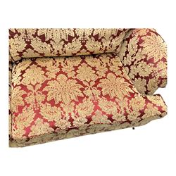 Duresta - pair of Grande three-seat sofas, traditional shaped with rolled arms and upholstered loose cushions, in red ground fabric with raised gold foliate pattern, on turned feet with brass castors 