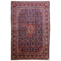 West Persian Mahal hand-knotted carpet, indigo field with central stylized angular medalli...