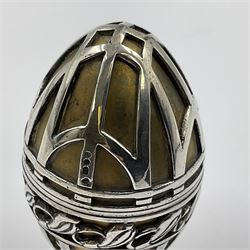 Modern silver limited edition Easter egg, no. 70/500, the gilded body decorated in relief with silver latticework and a band of flower heads, the detachable cover opening to reveal a gilt interior, each hallmarked St James House Company, London 1978, H5.5cm