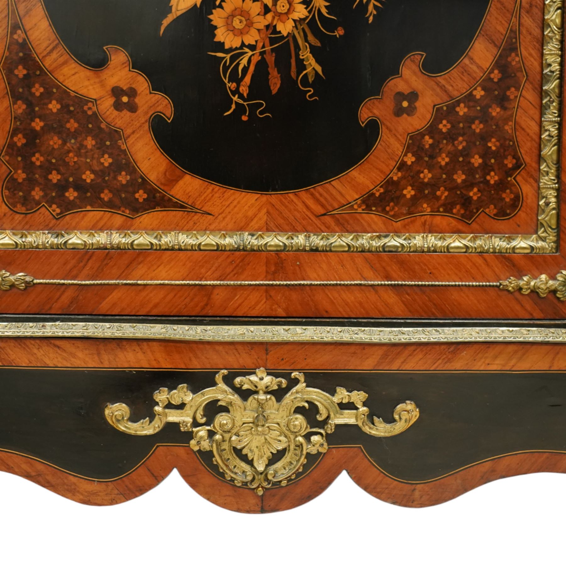 Late Victorian floral marquetry and ormolu mounted side cabinet, with white marble top above a frieze of floral inlay, single cupboard door revealing a shelved interior, with central floral bouquet panel within gilt-bronze border, flanked by gilt metal mounts of female masks and scrolls, on shaped plinth base