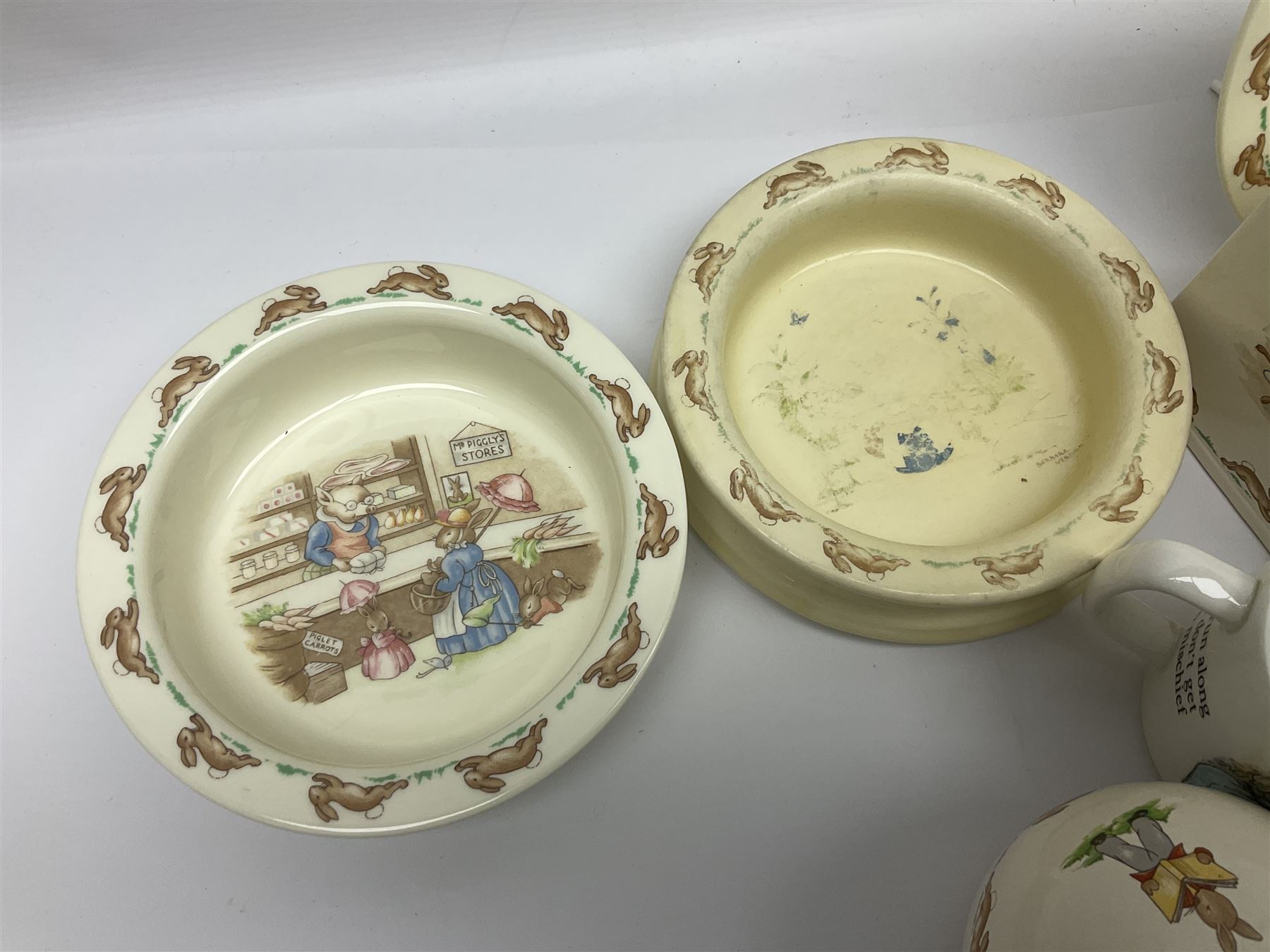 Collection of Royal Doulton Bunnykins and Wedgwood Peter Rabbit nursery ware, including cups, bowls, money boxes, etc 