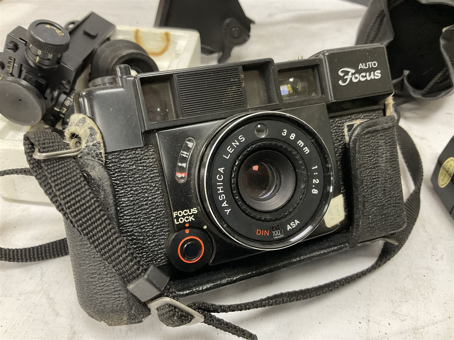 Quantity of cameras and accessories to include Olympus Trip 35, Minolta A f-EII 35mm, Yashica Auto Focus camera, Hanimex 35mm af camera in case, Kodak No.2A Folding Pocket Brownie camera in case, Minolta VLT-501 lens, etc