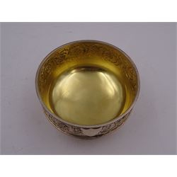 Victorian silver bowl, with embossed floral decoration and beaded rim, gilt interior and two applied shield cartouches, upon stepped circular foot, with a silver apostle spoon, with gilt bowl, both hallmarked George Unite, Birmingham 1883, bowl H5.5cm, within fitted tooled leather, silk lined case
