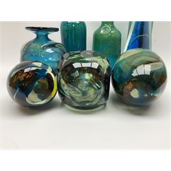 Quantity of M’dina art glass to include a streaked blue and green bottle form vase with captured bubble design and slender neck, H35cm, along with a paperweight, ovoid form vase and another vase all decorated in a blue, brown and white colour way, other contemporary glass examples etc with etched marks beneath