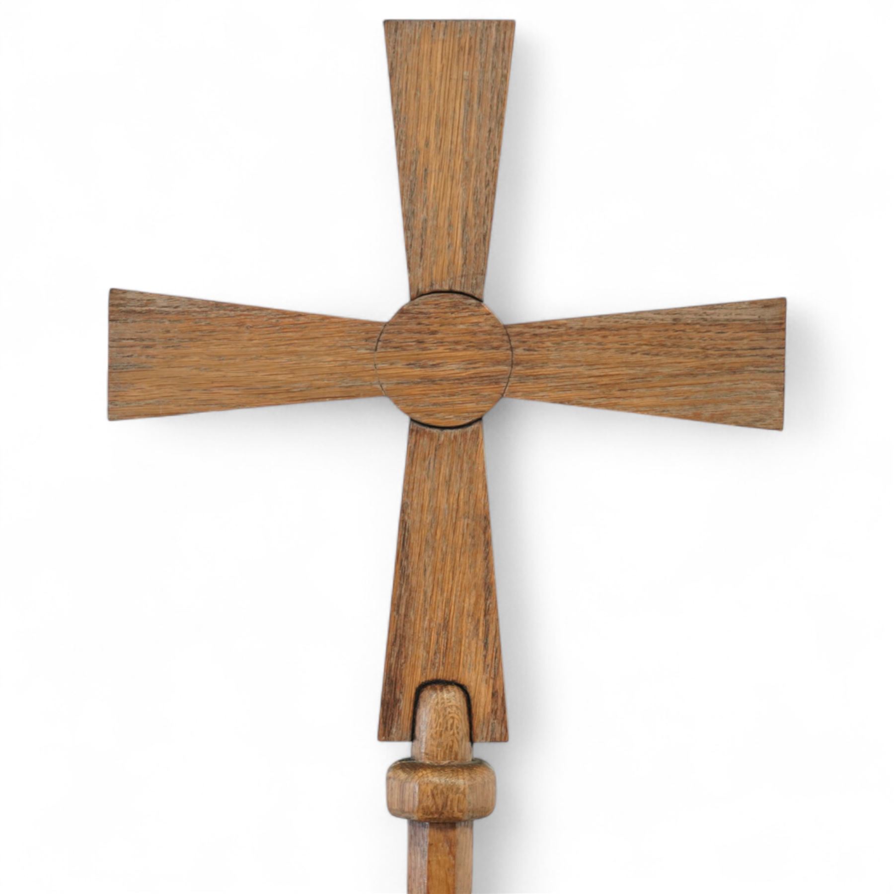 Early 20th century Arts and Crafts 6’ oak processional cross, the tapered cruciform head with circular boss, mounted on a long cylindrical octagonal shaped staff