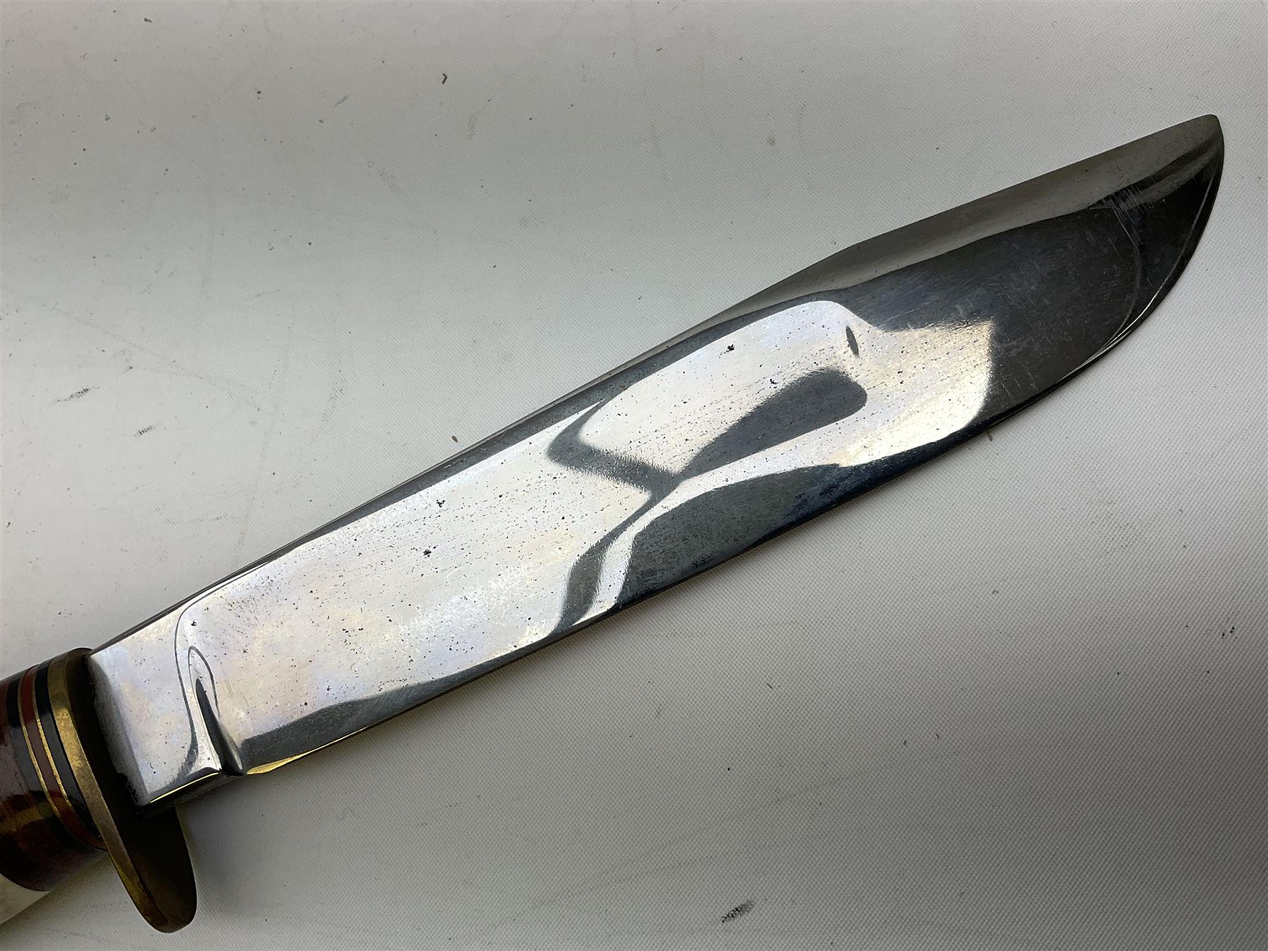 Bowie knife by J. Nowill & Sons Sheffield England Est. AD1700,  with 17.5cm steel blade, brass cross-piece, antler grip and alloy pommel; in leather sheath L32cm overall