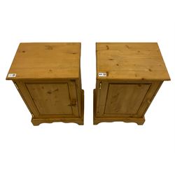Two small pine bedside cupboards, enclosed by panelled doors