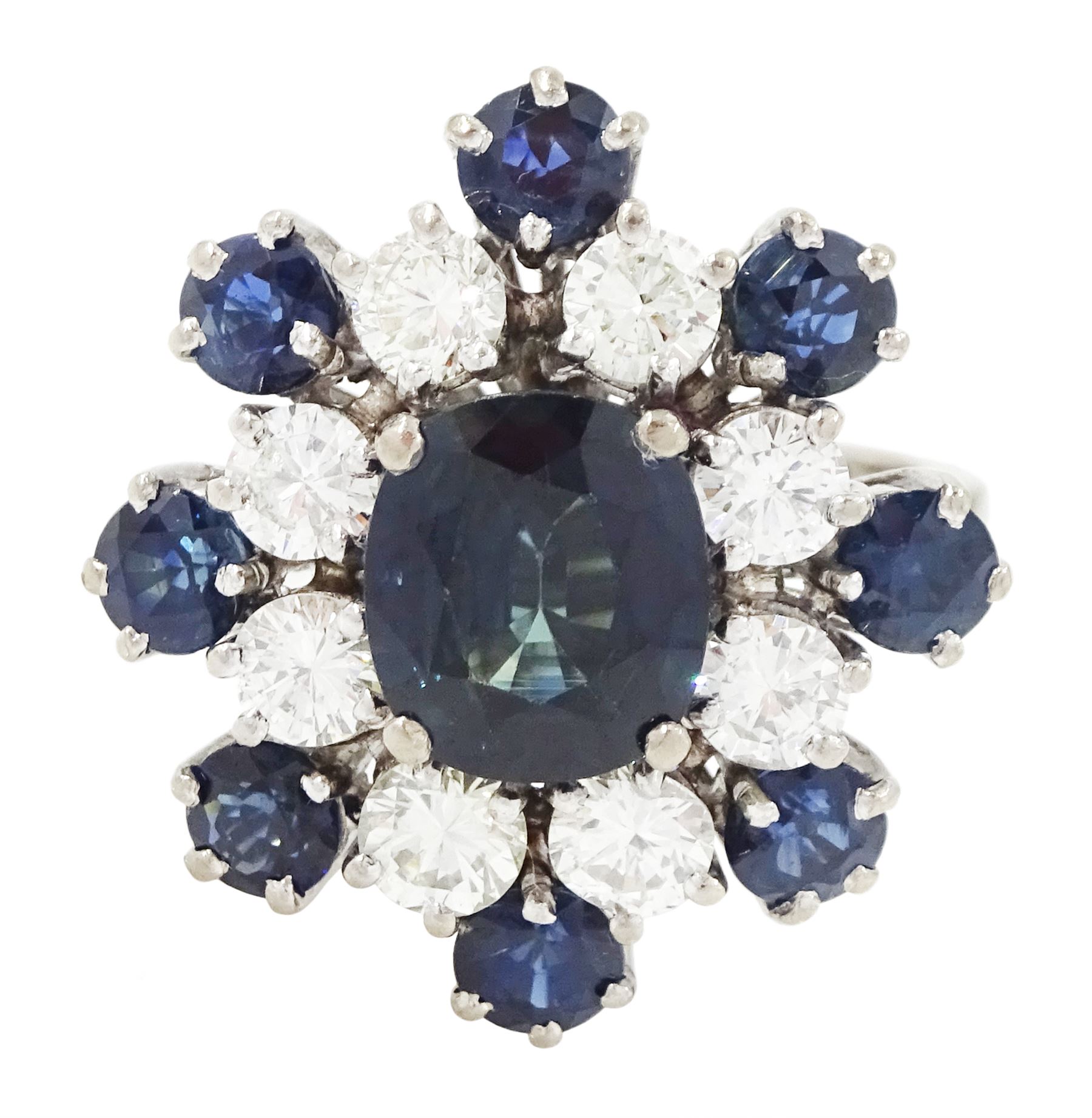 18ct white gold sapphire and diamond cluster ring, single oval cut sapphire of approx 1.85 carat, surrounded by eight round brilliant cut diamonds and eight round cut sapphires, stamped Graff, total sapphire weight approx 3.40 carat, total diamond weight approx 1.35 carat