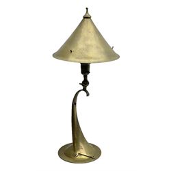 Arts & Crafts Jesson, Birkett & Co, brass table lamp or wall light, designed by Thomas Birkett, the tapering stem with adjustable ball pivot supporting a conical shade with tapering final with ball terminal, upon a circular domed base pierced for wall mounting, shade positioned upright overall H57cm

Often misattributed to Arthur Stansfield Dixon for Birmingham Guild of Handicraft, this particular lamp was designed by Thomas Birkett.
In the late 1890's Birkett worked as a metalwork at the Birmingham Guild, before later joining the Faulkner Bronze Company which went on to become Jesson, Birkett & Co in 1904. The lamp features in lighting catalogues from the firm under the model no E490.

