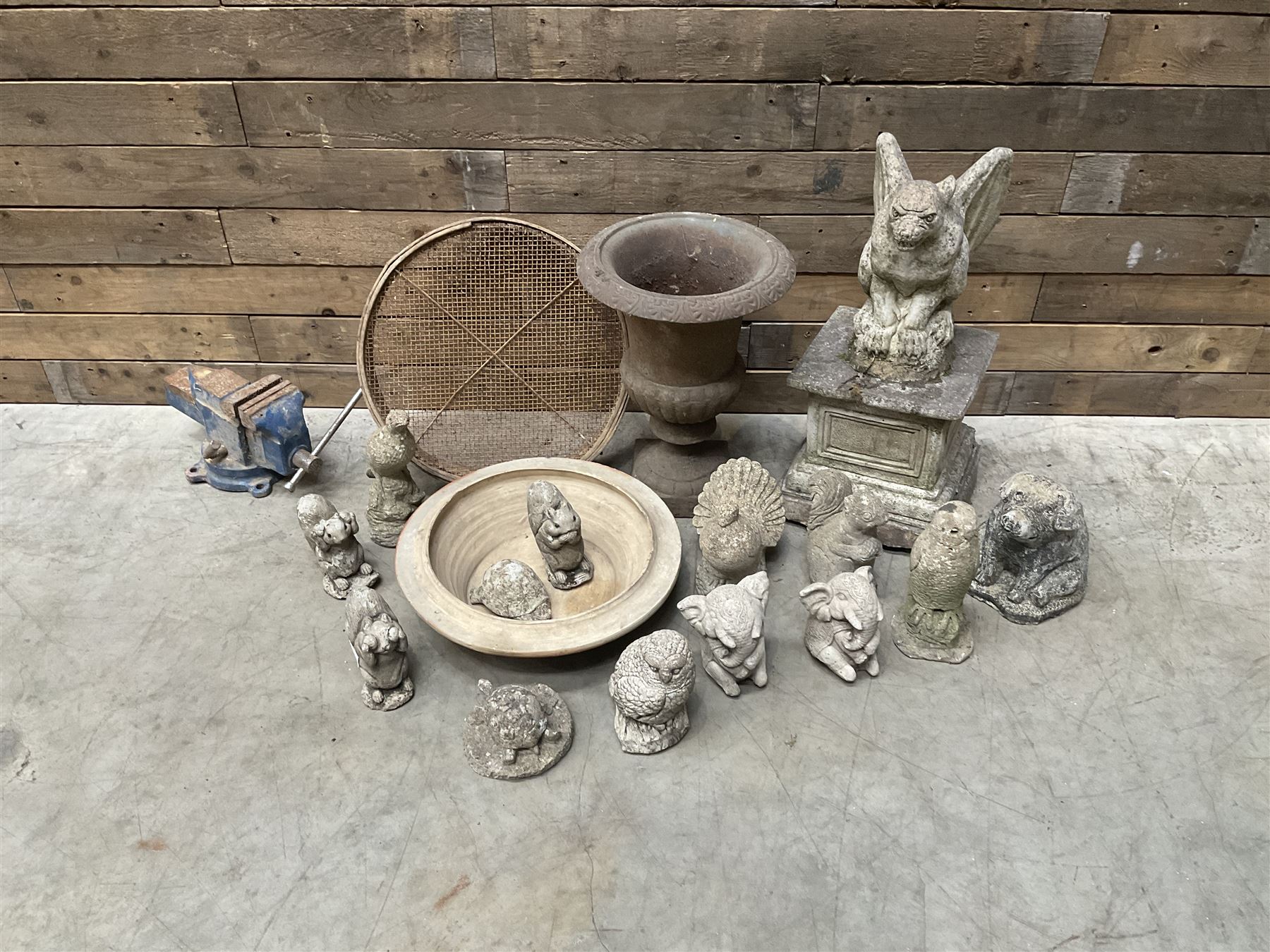 Small Victorian style cast iron urn, cast stone griffin on plinth, 13 garden figures, old vice and other items. 