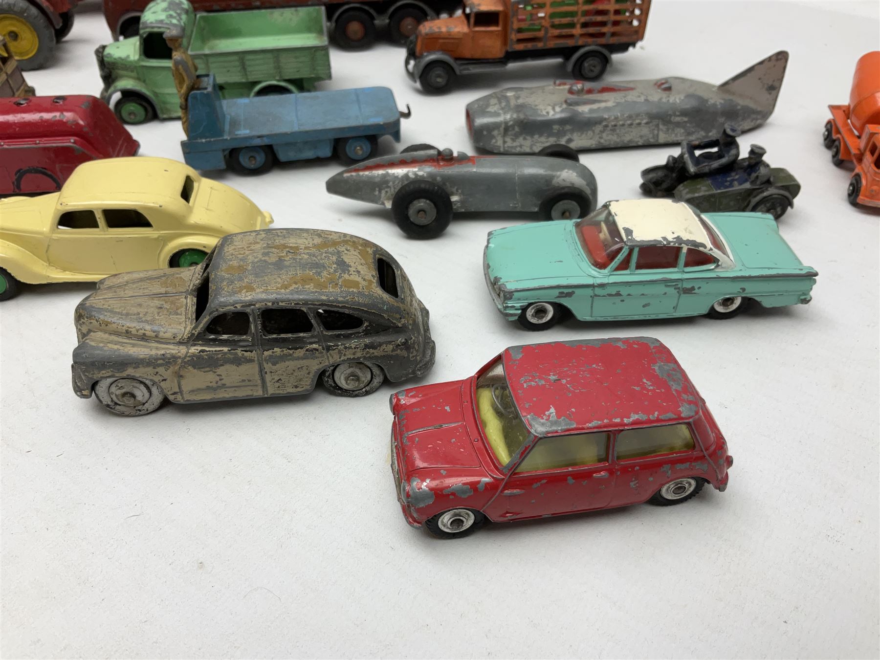Dinky - sixteen unboxed and playworn die-cast models including Foden lorry, Big Bedford lorry with Halesowen Farm Trailer, Thunderbolt land speed record car, Spirit of the Wind racing car, market garden truck, Bedford tipper, station wagon, tanker, motorcycle combination etc; two Corgi models; and five Matchbox/Lesney models (23)