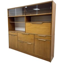 Mid-20th century teak sectional wall unit, combination of cupboards and drawers, raised sliding glass doors