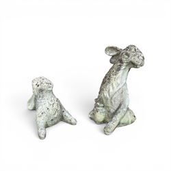 Two weathered cast stone garden hares