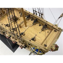 Wooden kit built model of HMS Neptune, 1:90 scale, with detailed rigging to three masts and a row of cannons to either side, upon ebonised wooden base, including stand H71cm