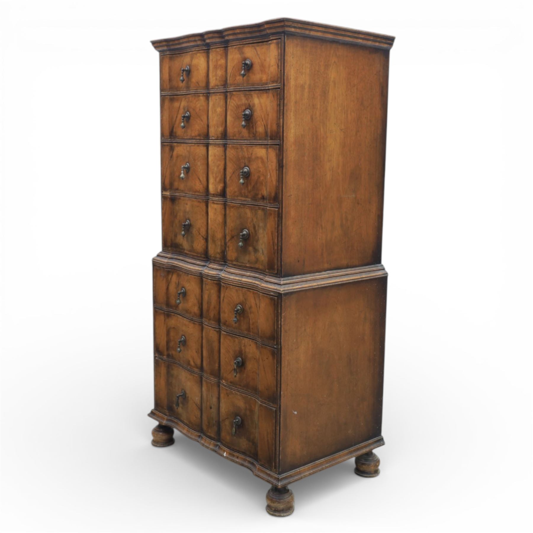 Early 20th century Queen Anne revival walnut chest on chest, the shaped cornice over an arrangement of four long drawers above three further long drawers, figured walnut veneers with feather banding and crossbanding, on turned bun supports