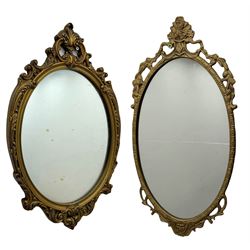 Giltwood oval wall mirror with carved Ro