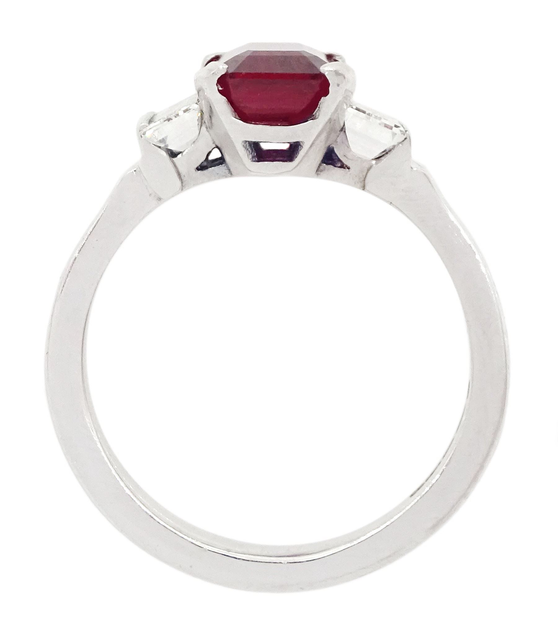 18ct white gold ruby and diamond three stone ring, single emerald cut Thai ruby of approx 2.00 carat, with a baguette cut diamond set either side, hallmarked, total diamond weight approx 0.60 carat