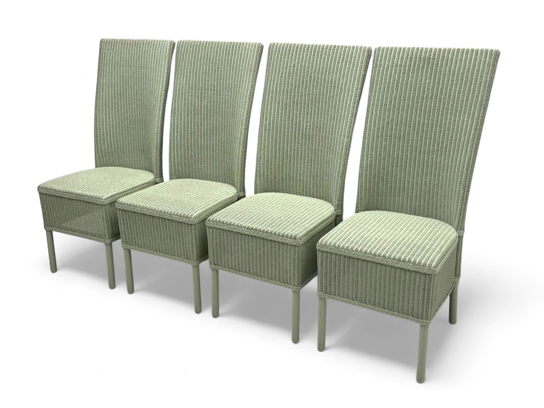 Set of four Lloyd Loom dining chairs, each with woven high back and seat in sage green finish, raised on matching painted tubular supports