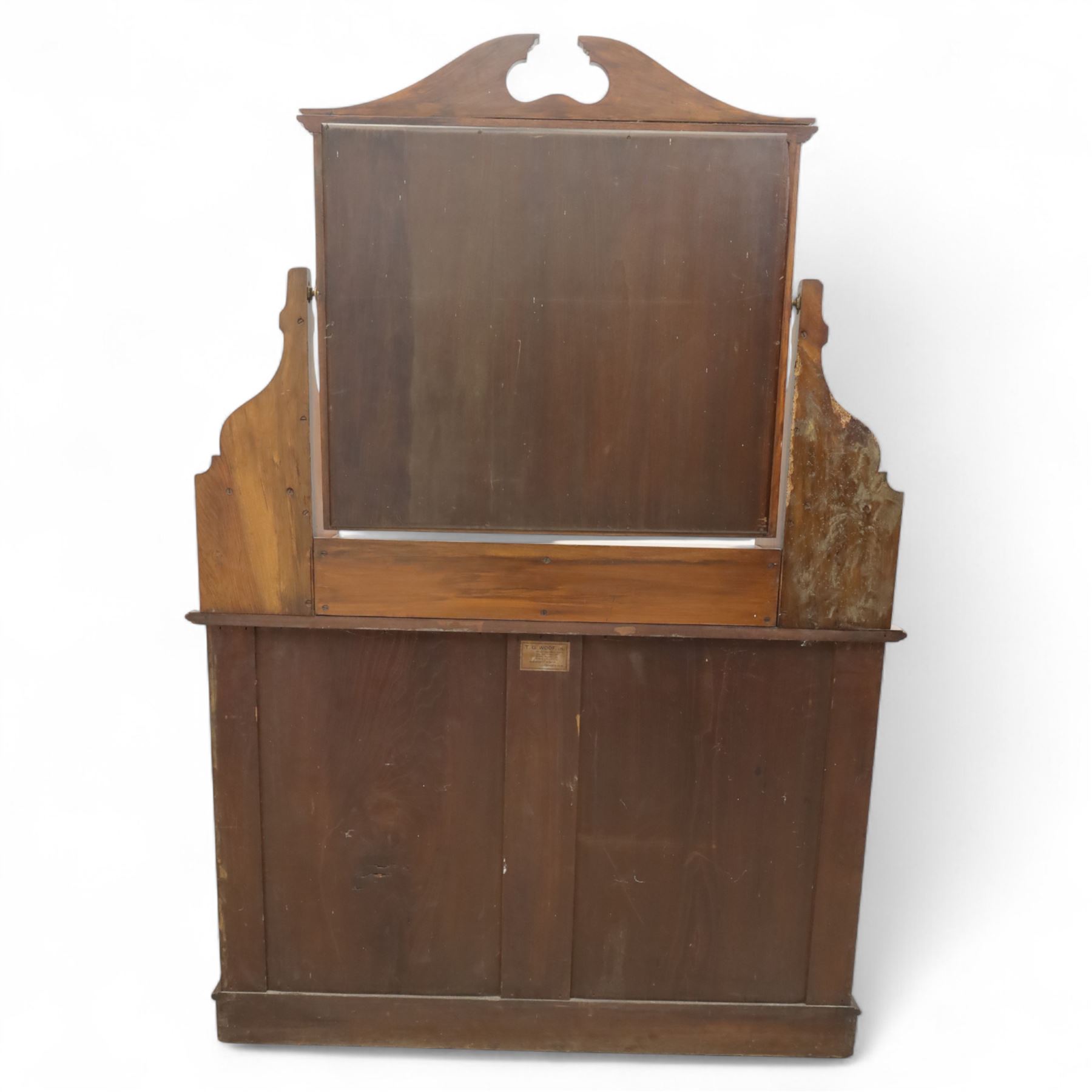 Edwardian walnut dressing chest, rectangular top surmounted by a mirror frame with shaped pediment on swing supports above two short frieze drawers over two short and three long graduated drawers fitted with brass foliate handles, raised on a plinth base