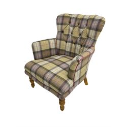 Traditional shaped armchair, upholstered in deep buttoned purple tartan fabric with red piping, raised on turned and tapering stained beech supports