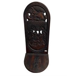 Carved hardwood birthing stool, back carved and pierced with elephant and tribal scenes