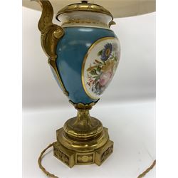 Sevres style table lamp, the ovoid body with twin gilt metal handles, hand painted with a gilt framed panel of cherubs to one side, and flowers to the other, against a bleu celeste type ground, upon a gilt metal socle and plinth base, with cream fabric shade, lamp H39cm