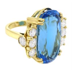 18ct gold oval blue topaz ring, with four round brilliant cut diamonds set either side, topaz approx 31.10 carat, total diamond weight approx 2.25 carat