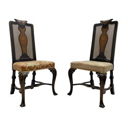 Early 20th century set of four stained beech framed dining chairs, scrolled cresting carved with trailing bellflowers, caned back with vasiform splat inlaid with a man holding a horn whilst riding on a goat, needlework upholstered seat, on bellflower and C-scroll carved cabriole supports with scrolled terminals, united by shaped and pierced stretcher rails 